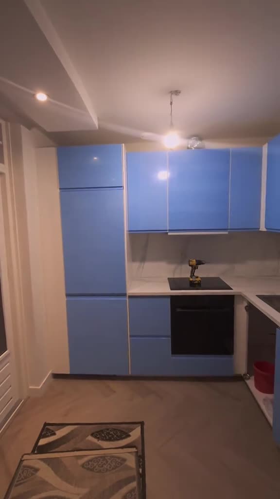 Blauwe IKEA-keuken in hoekopstelling, bovenkasten in één lijn met de hoge kasten